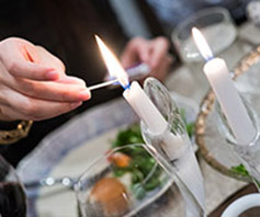 Photo of a person lighting a candle. Links to Gifts That Pay You Income