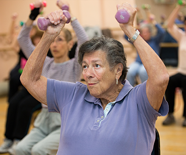 Photo of a woman lifting weights. Links to Gifts of Appreciated Securities