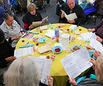 Photo of a group of people reading. Links to What to Give Photo of a group of people reading. Links to What to Give